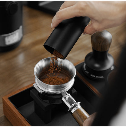 MHW-3BOMBER coffee poured through a silver steel ring from a separate dosing cup