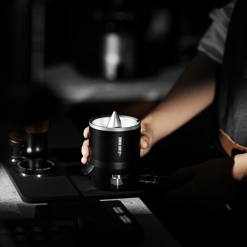 MHW-3BOMBER DR5566 black SE Pro shaker held above a counter with its central cone visible; surrounding tools not included