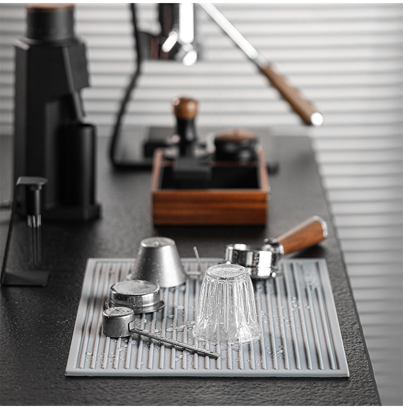 MHW-3BOMBER grey drying pad below glasses and coffee tools; tools not included