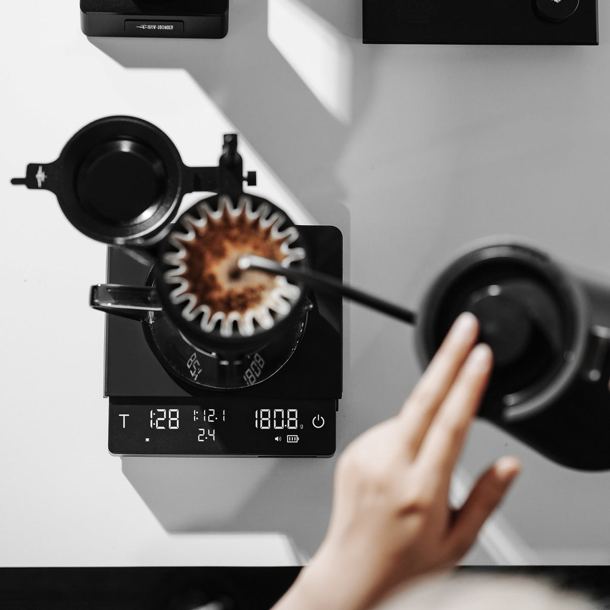 MHW-3BOMBER ES5663 black Cube Coffee Scale 3.0 Pro Max viewed from above during pour-over brewing; kettle, dripper and server are separate props