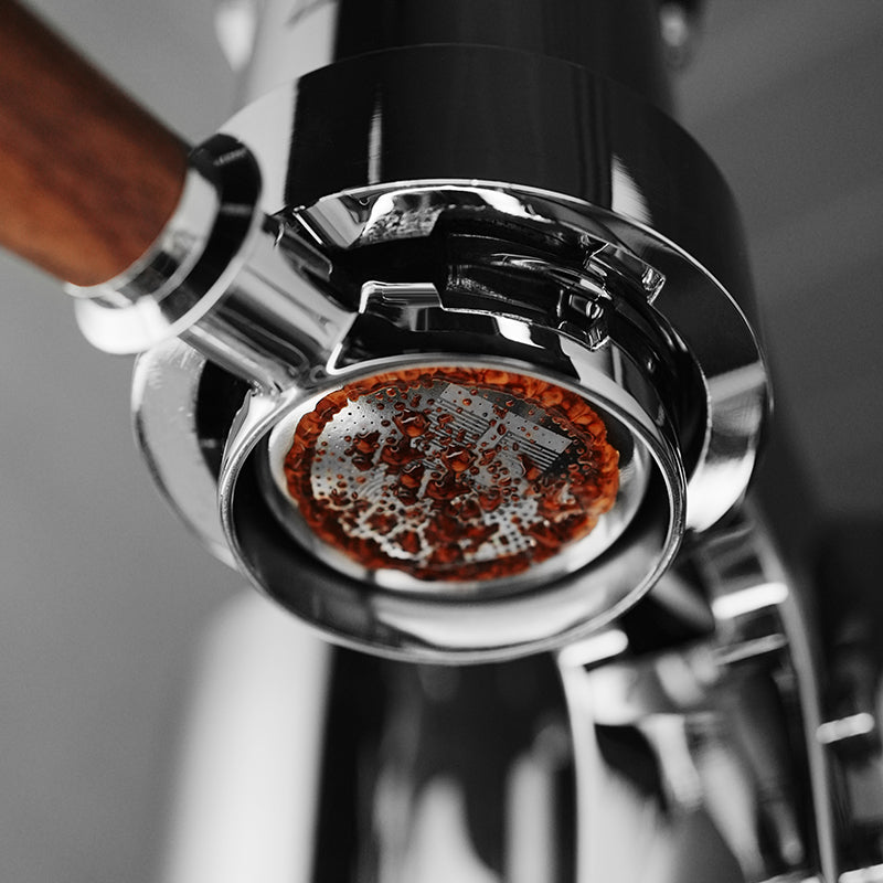 MHW-3BOMBER FB5648 silver DH basket extracting espresso in a bottomless portafilter; portafilter and machine are not included.