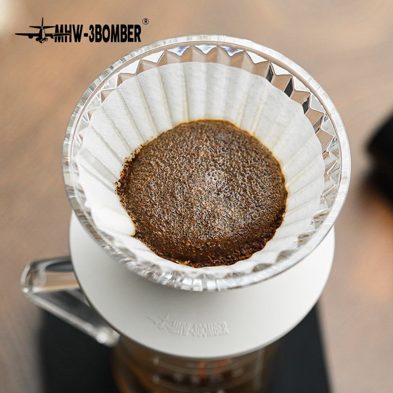 MHW-3BOMBER FC5875W Elf Glass Dripper — overhead view of the coffee bed in the clear white-base dripper