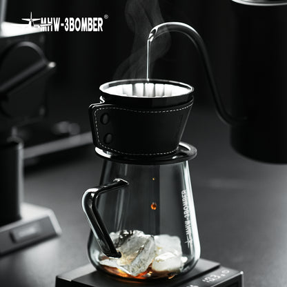 MHW-3BOMBER Meteorite Dripper FC6555B, Obsidian Black, pouring over a glass server with ice; server and kettle are props