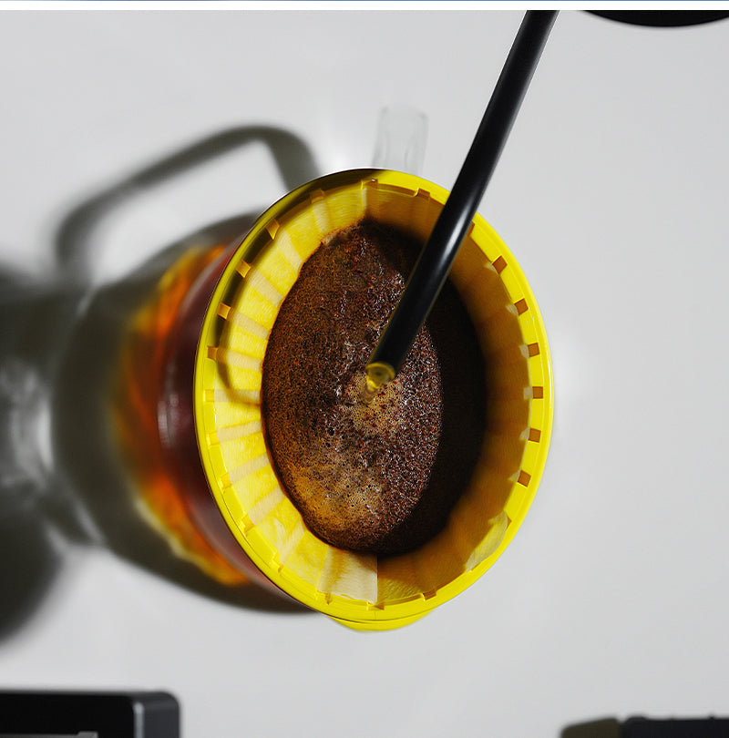 MHW-3BOMBER yellow Oval dripper with coffee grounds seen from above