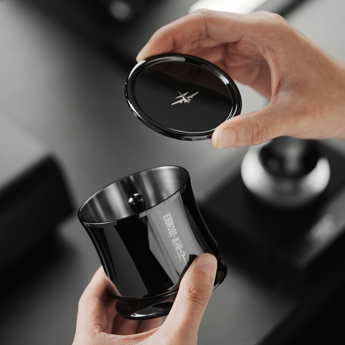 MHW-3BOMBER black FlowLight dosing tool lid being opened by hand