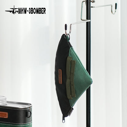 MHW-3BOMBER FPB6526 black and green filter-paper storage bag hanging alone from a rack; rack and nearby container are not included