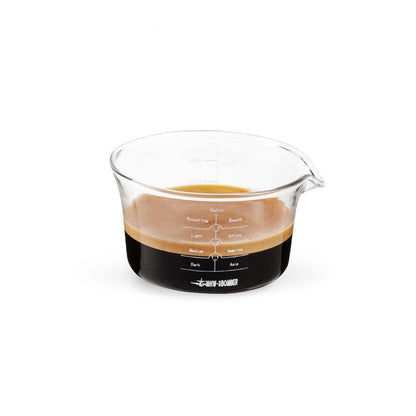 MHW-3BOMBER G5052 clear 120 ml single-spout glass measuring cup containing espresso; coffee is a serving example