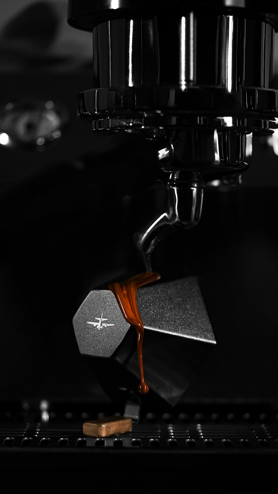 MHW-3BOMBER Black Prism cup under an espresso spout, overhead view