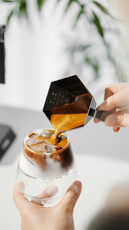 MHW-3BOMBER Black Prism cup pouring espresso into a separate glass