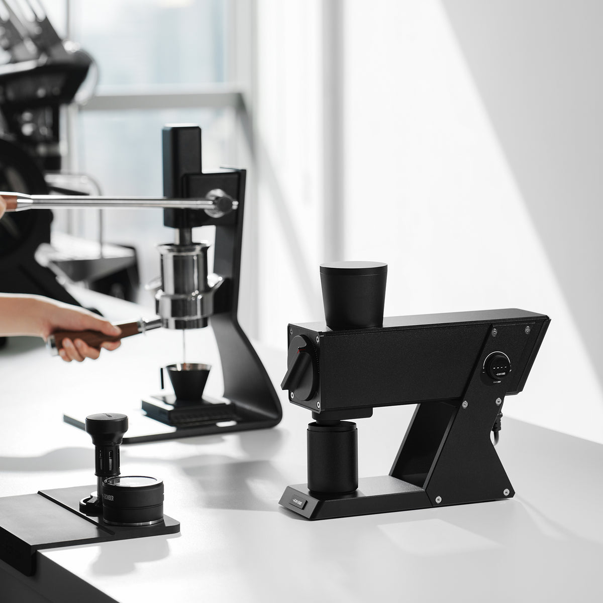 MHW-3BOMBER F74 Navigator G5917 Black grinder, side view on a brewing counter