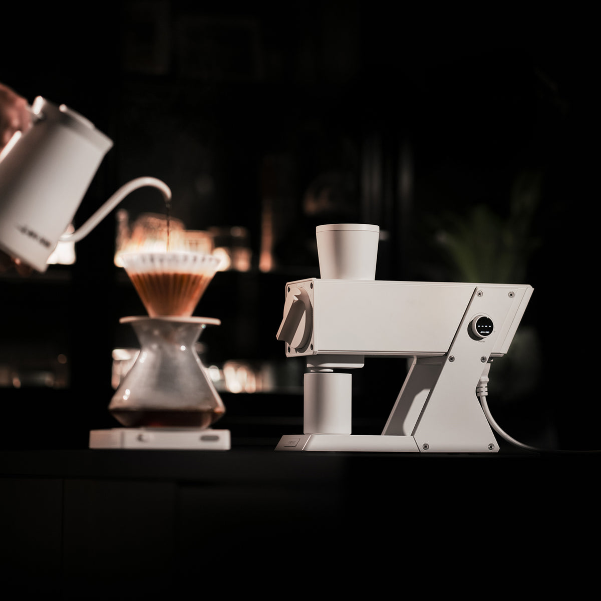 White F74 Navigator grinder in a coffee-preparation scene; brewing props not included.