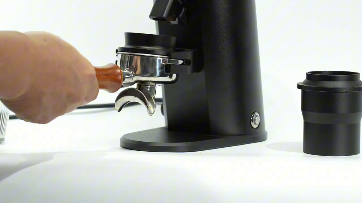 HiBREW G64 Plus black coffee grinder – positioning a portafilter on the support; portafilter sold separately