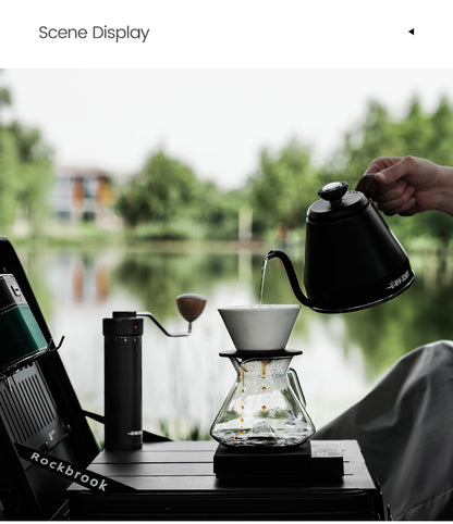 MHW-3BOMBER clear Hill coffee server beneath a dripper beside a window