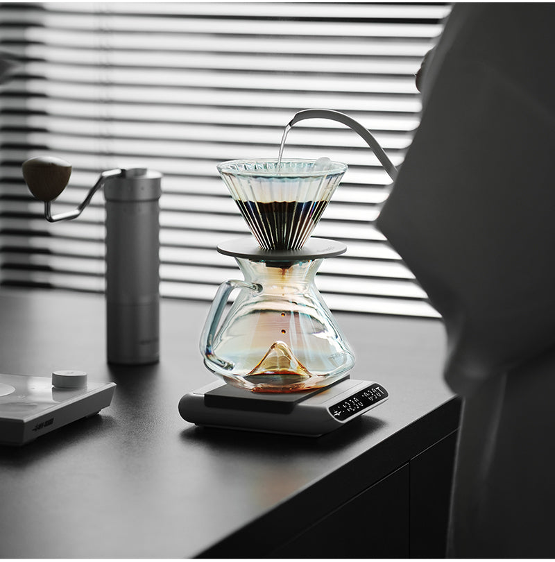 MHW-3BOMBER clear Hill coffee server brewing on a scale in window light