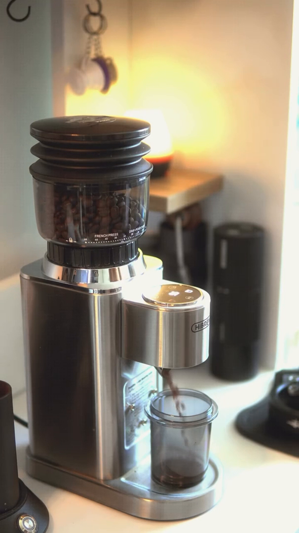 HiBREW G7 Silver grinder dispensing ground coffee into its receiving cup