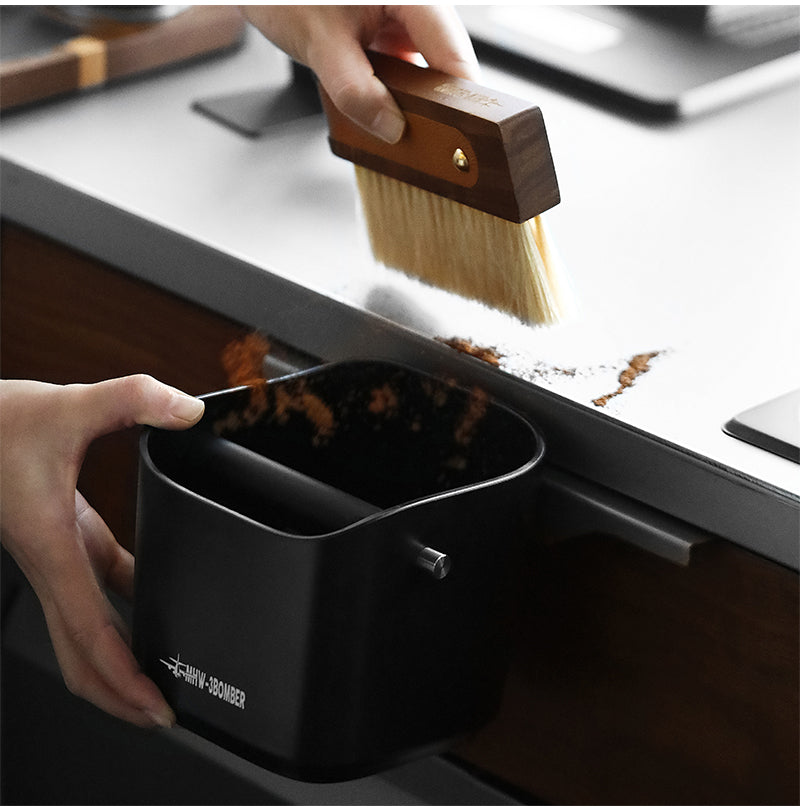 MHW-3BOMBER brush sweeping coffee grounds into the black box; brush separate