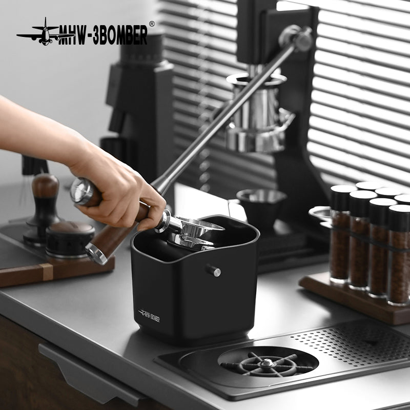 MHW-3BOMBER portafilter used at the black knock-box bar; portafilter separate