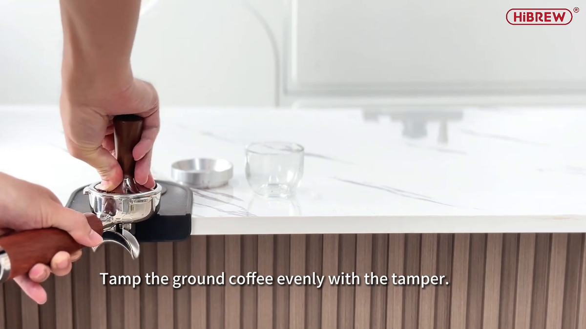 HiBREW H13 Silver — tamping coffee in the handled portafilter