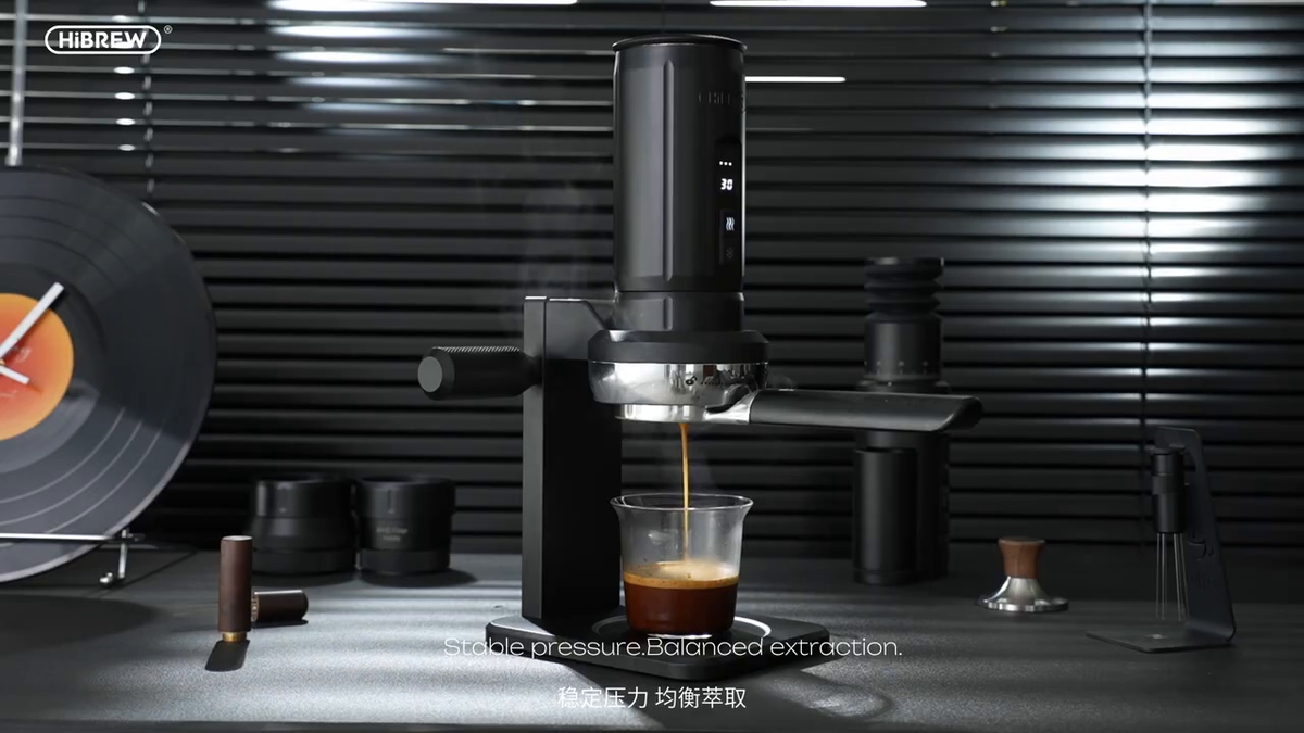 HiBREW H4C Max extracting espresso on the metal station; glass is separate.