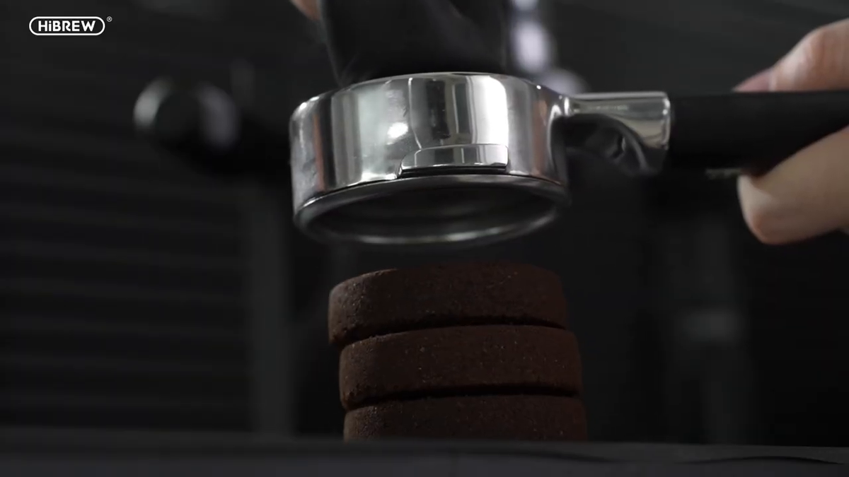 HiBREW H4C Max portafilter basket after extraction and coffee-puck removal.