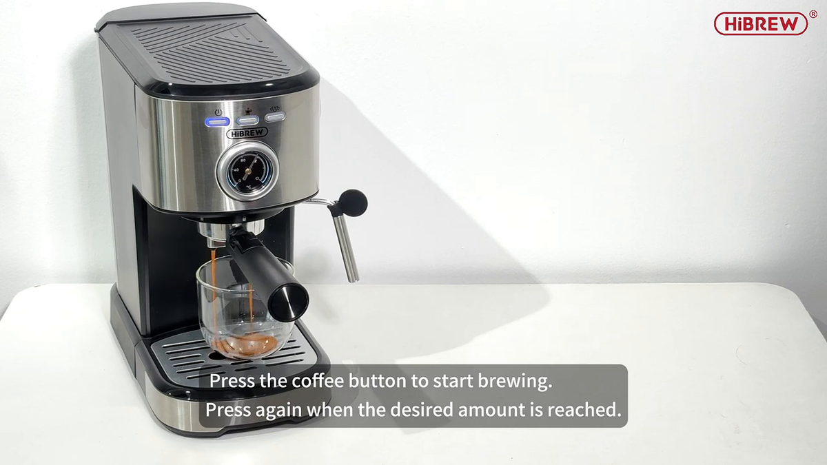 HiBREW H5A extracting espresso through its portafilter; glass is separate.