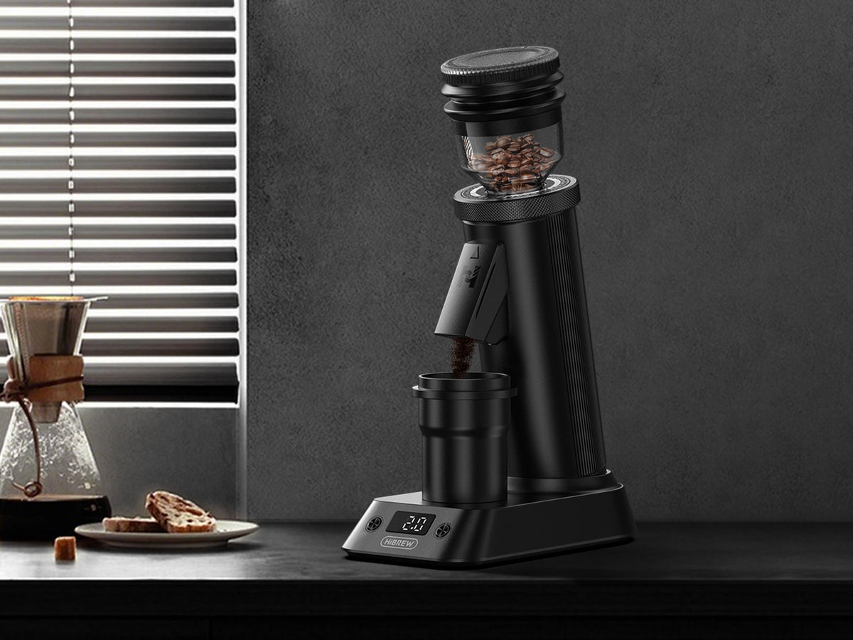 HiBREW G5 Plus — G5 Plus grinder beside a window, showing the display and chute