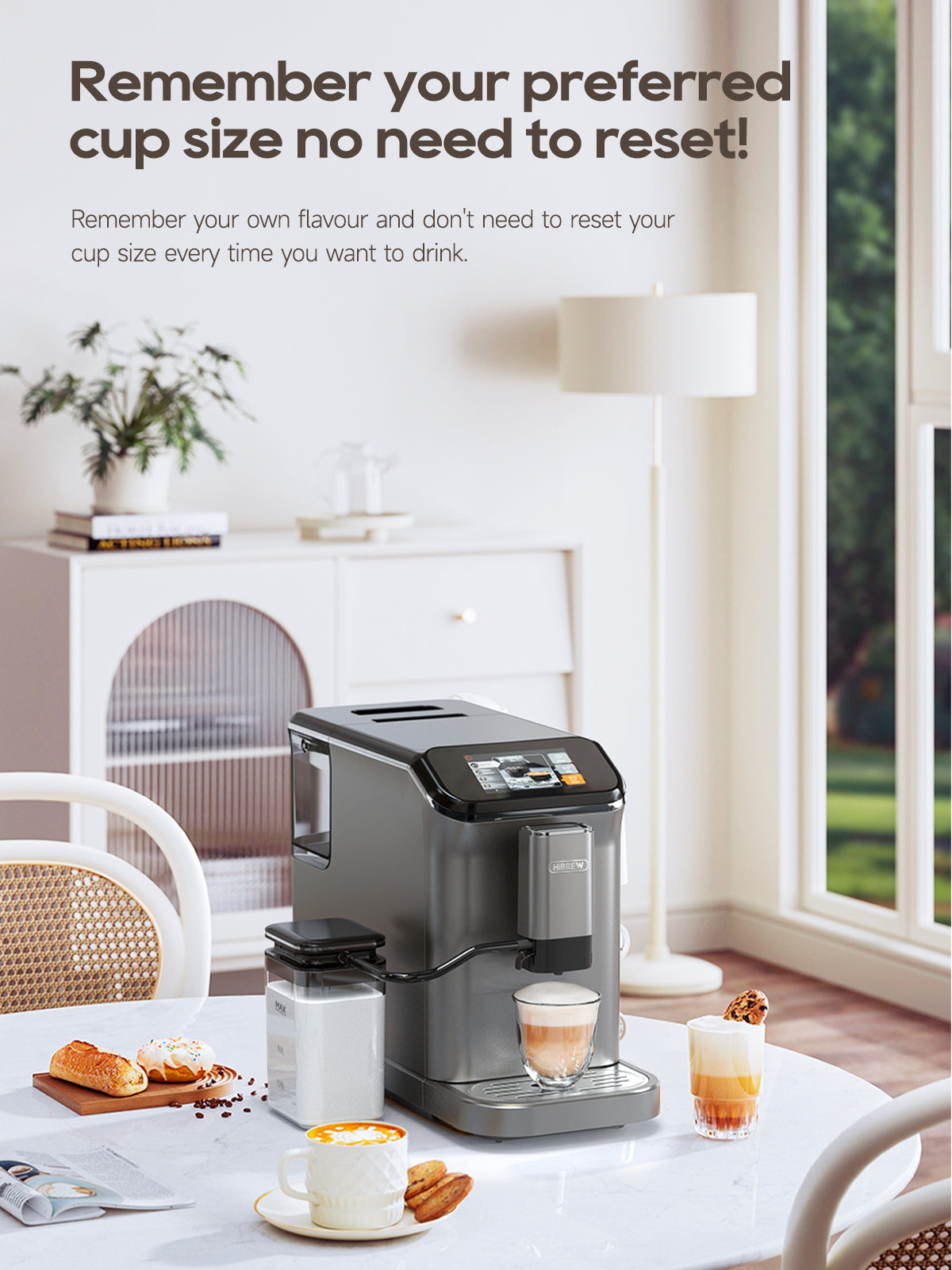 HiBREW H16 black machine and separate milk container on a kitchen table; food and cups are scene props