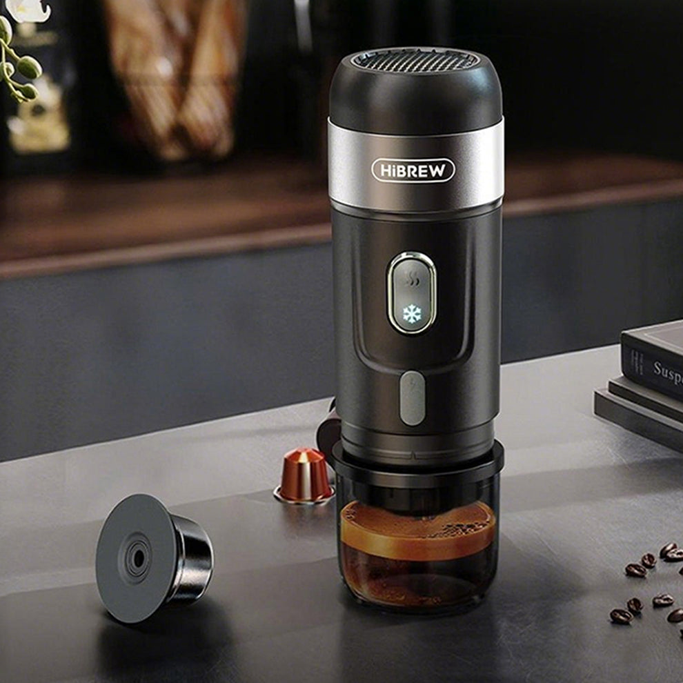 HiBREW H4A — Black brewer on a counter with capsule adapter beside it; cups are props