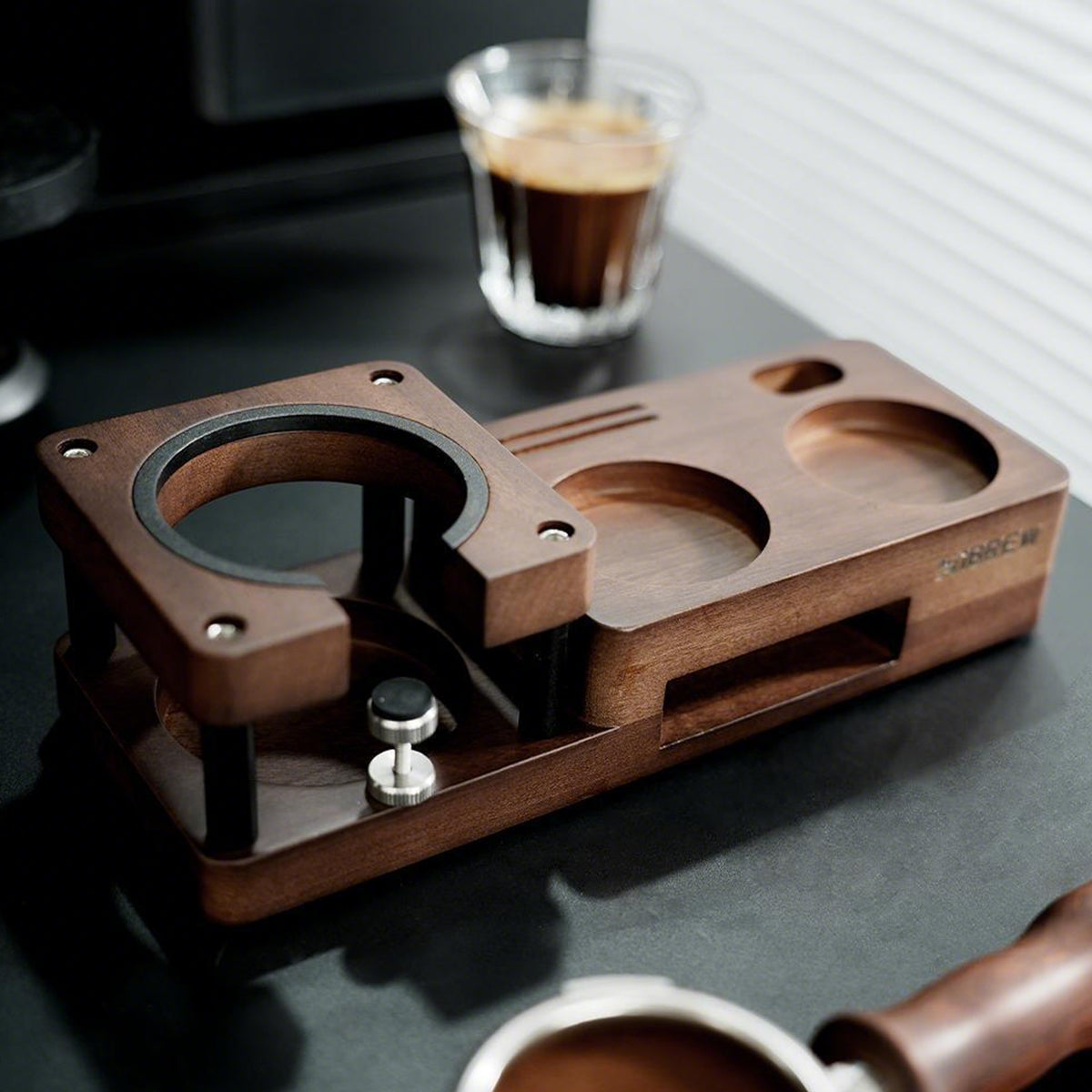 HiBREW wood tamping station, empty support and recessed tool positions on a dark countertop. Cups and coffee are demonstration props, not included.