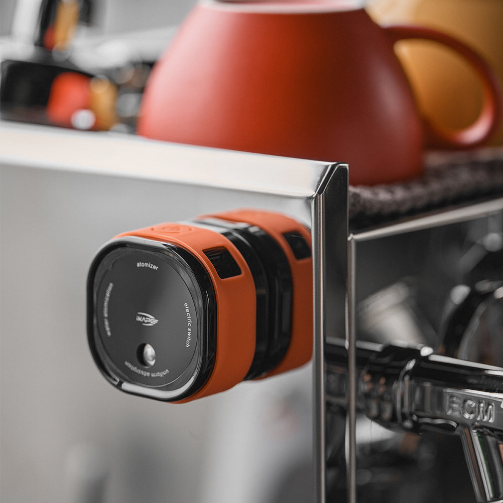 IKAPE electric coffee bean atomizer, black and orange, magnetic mounting on espresso machine
