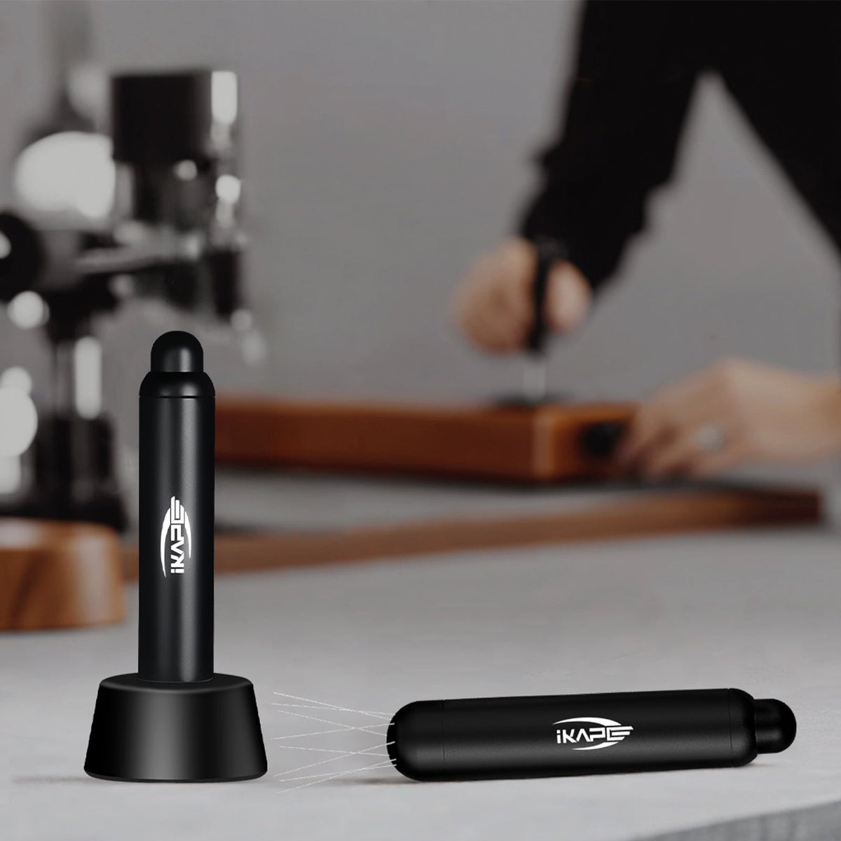 IKAPE black retractable WDT tool and stand on a coffee counter; manufacturer reference scene