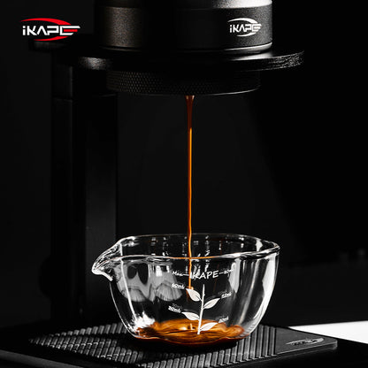IKAPE Glass Petal measuring cup collecting espresso under a portable coffee maker