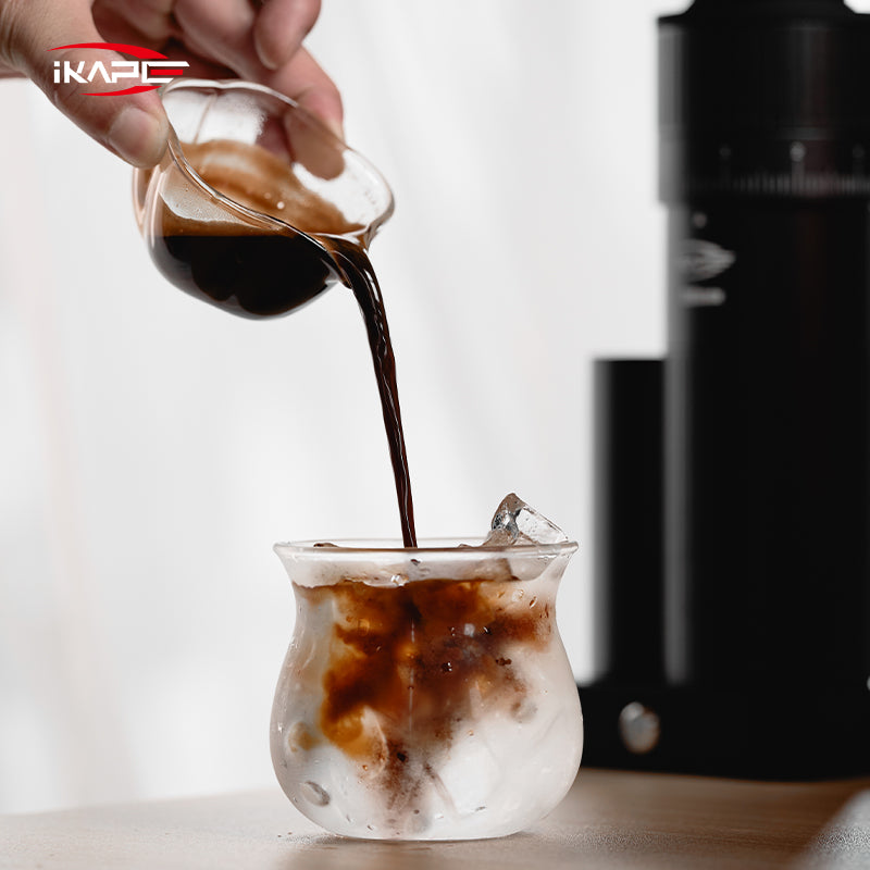 IKAPE Glass Petal measuring cup pouring coffee into a serving glass