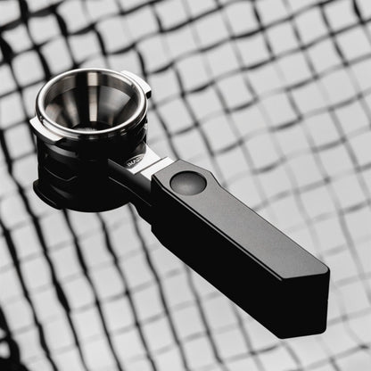 IKAPE Polaris black 58mm dual-ear flat-base bottomless portafilter; manufacturer scene 2; other equipment not included