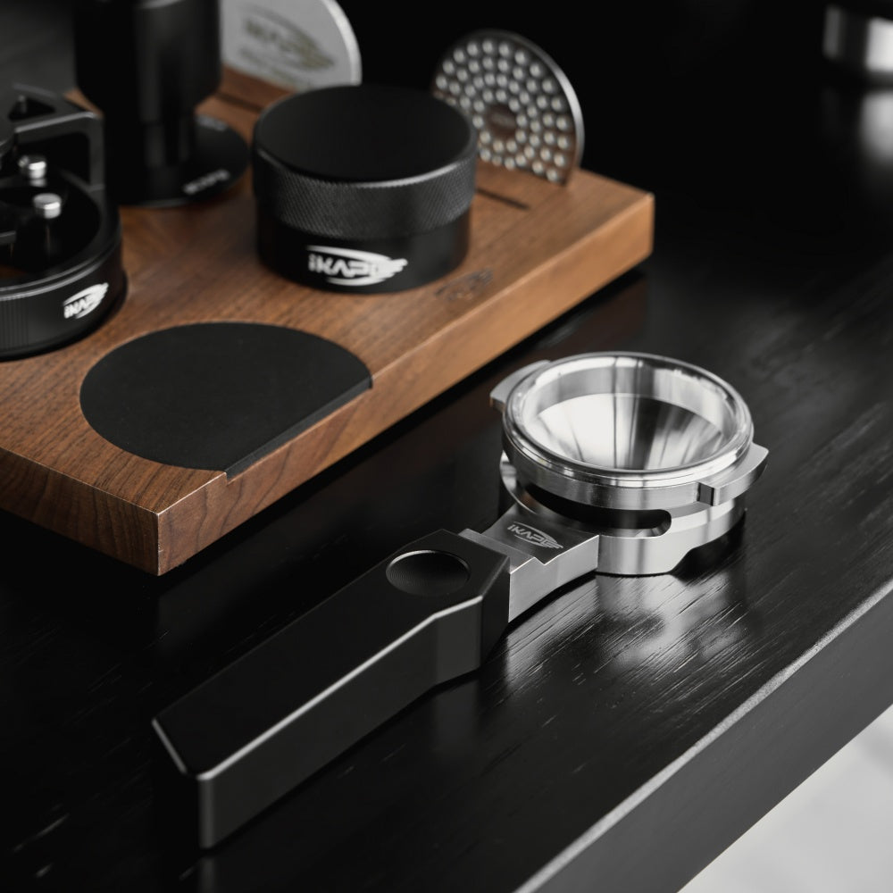 IKAPE Polaris black 58mm dual-ear flat-base bottomless portafilter; manufacturer scene 3; other equipment not included