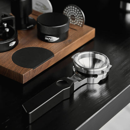 IKAPE Polaris black 58mm dual-ear flat-base bottomless portafilter; manufacturer scene 3; other equipment not included