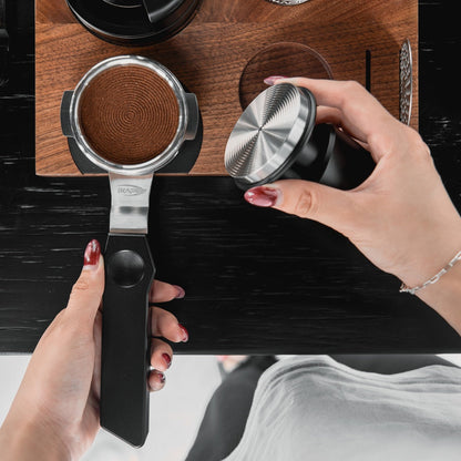 IKAPE Polaris black 58mm dual-ear flat-base bottomless portafilter; manufacturer scene 5; other equipment not included