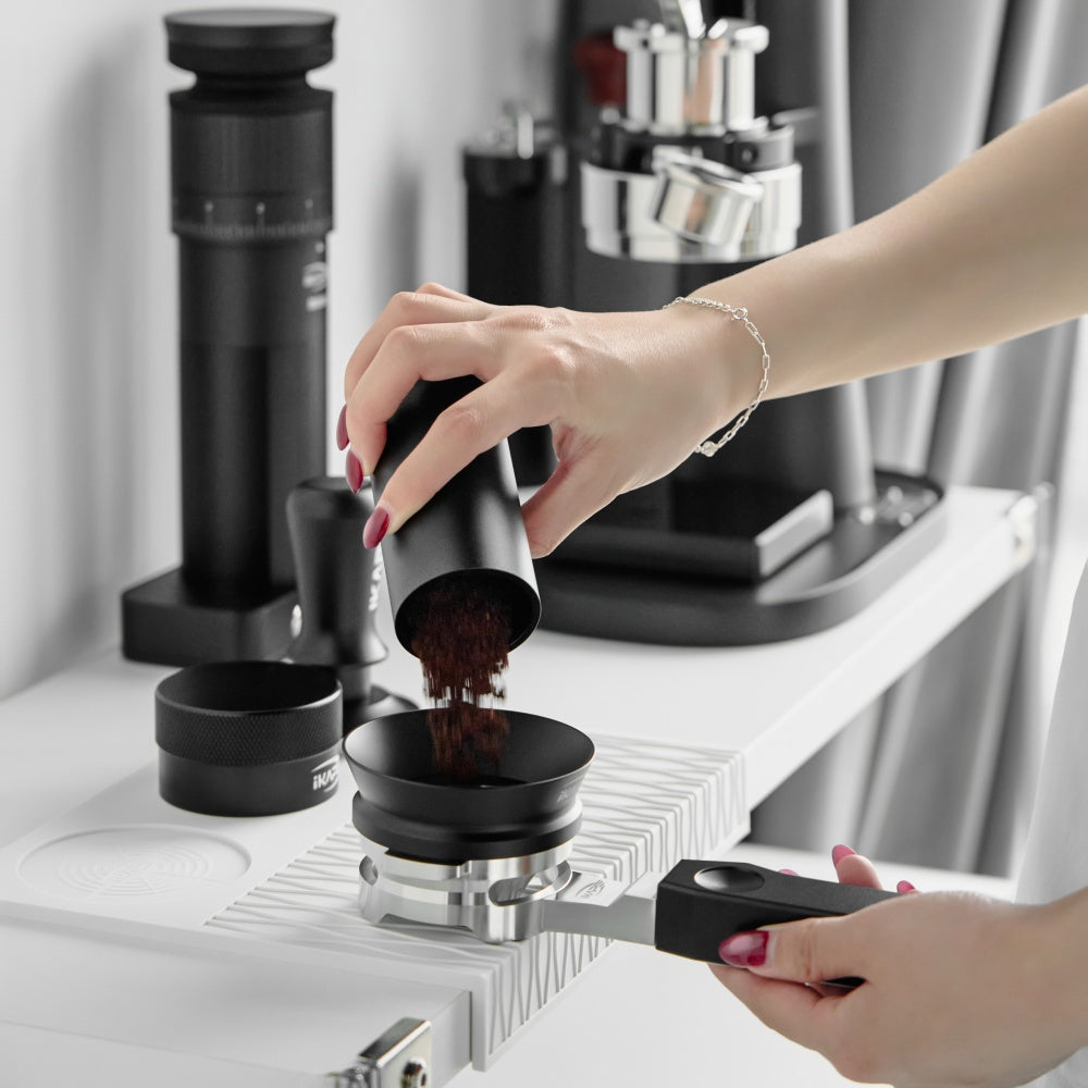 IKAPE Polaris black 58mm dual-ear flat-base bottomless portafilter; manufacturer scene 8; other equipment not included