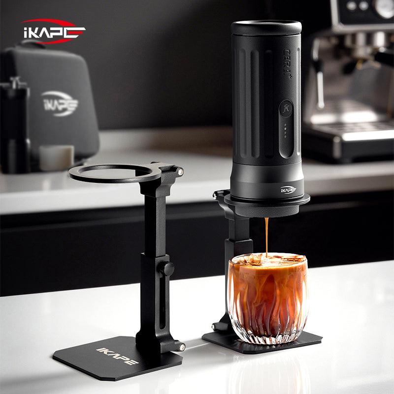IKAPE folding stand beside a portable espresso maker on a coffee counter