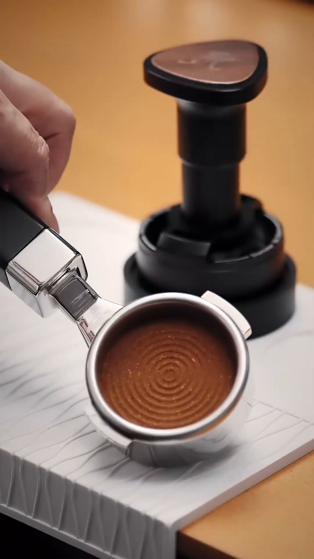 Prepared coffee puck beside the IKAPE UniPress 58.35 mm; portafilter sold separately.