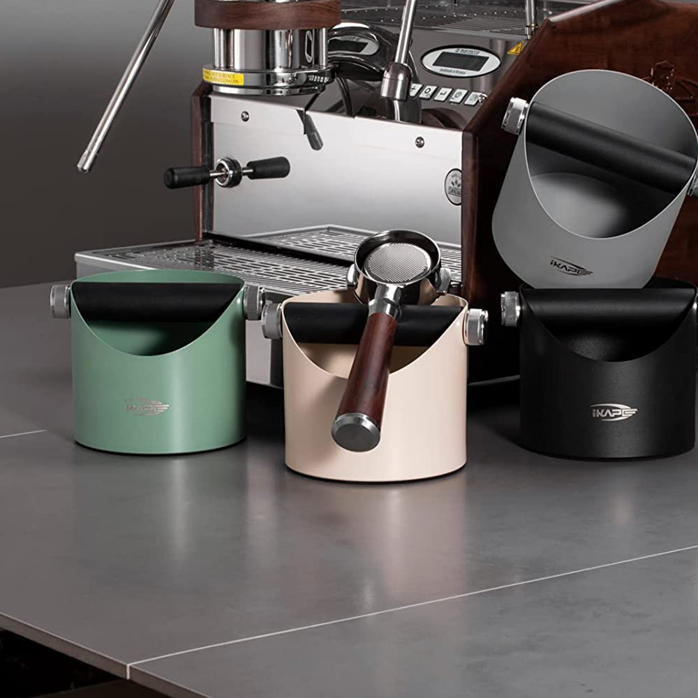 IKAPE V1 black metal espresso knock box on a coffee counter