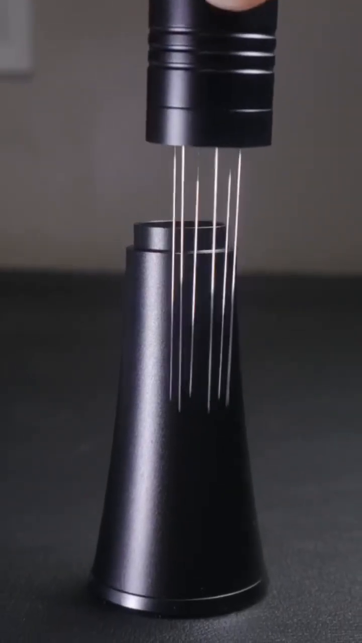 IKAPE V2 Black WDT tool lifted from its conical storage stand