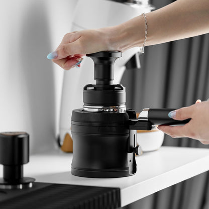 IKAPE V4 black rotary adjustable portafilter stand, manufacturer usage photograph 6; shown portafilter and preparation tools are props