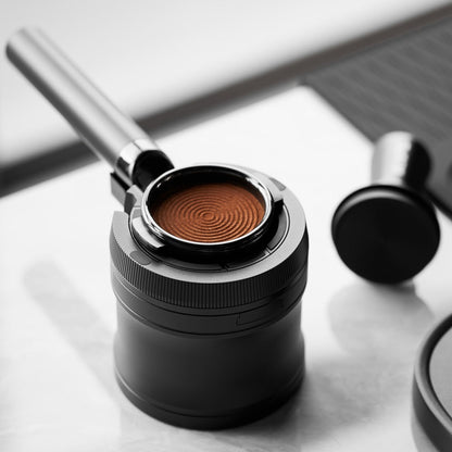 IKAPE V4 black rotary adjustable portafilter stand, manufacturer usage photograph 7; shown portafilter and preparation tools are props