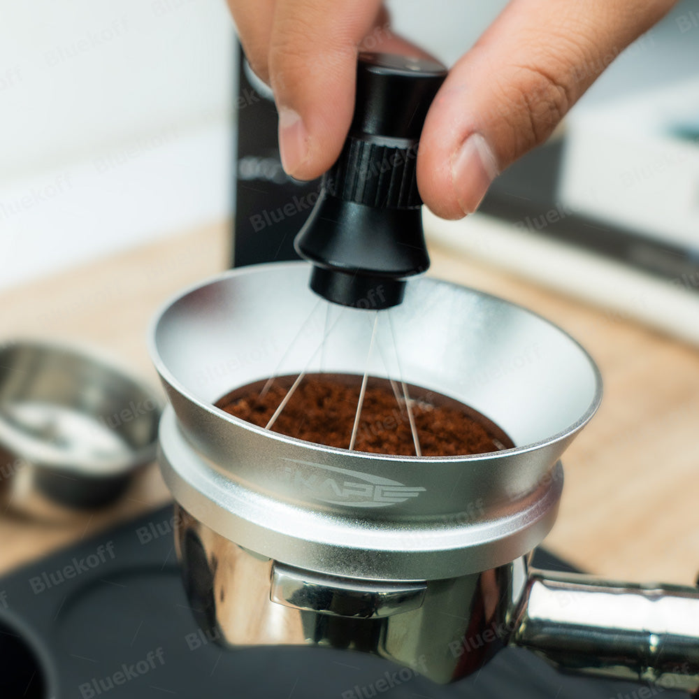 IKAPE Black adjustable WDT tool stirring grounds in a portafilter, side view