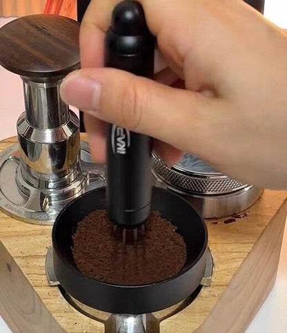 IKAPE black retractable WDT tool distributing coffee grounds in a portafilter