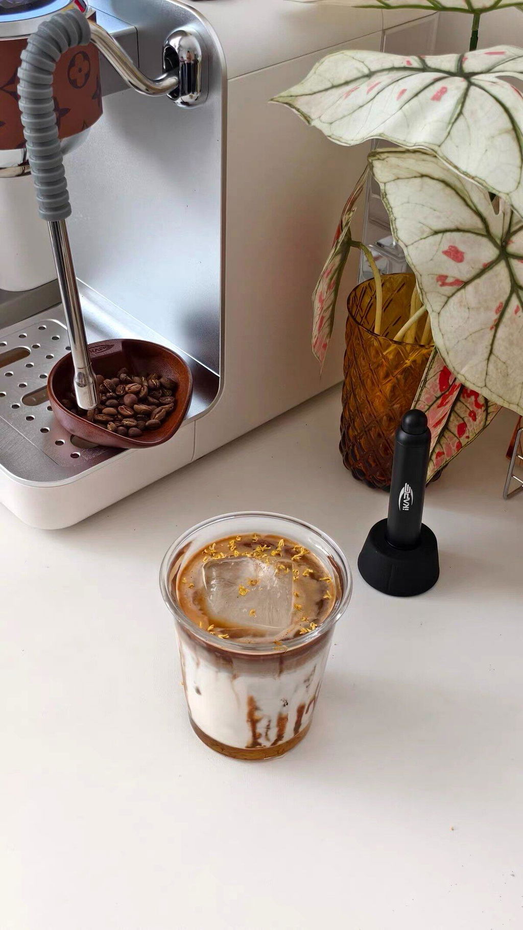 IKAPE black retractable WDT tool stored upright in its stand on a coffee counter