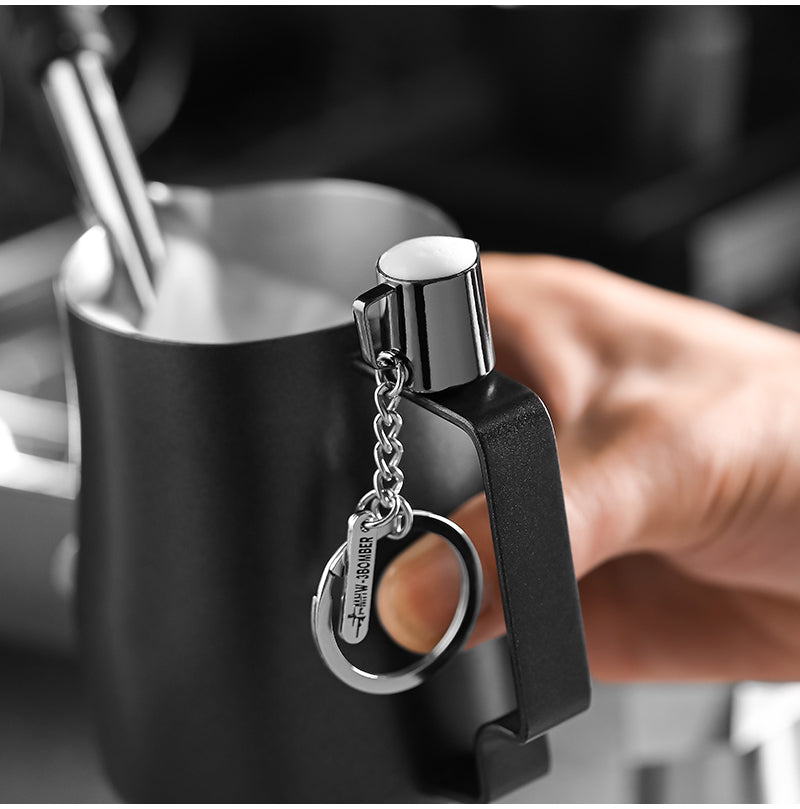 KC5700 miniature milk-pitcher keychain beside a grinder; grinder is a photography prop