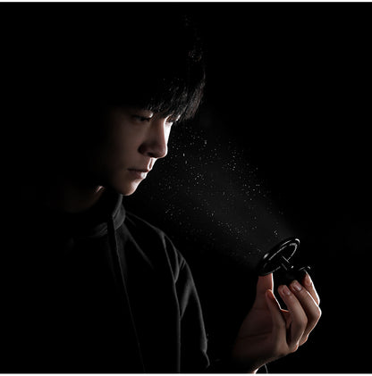 MHW-3BOMBER M5503 black mirror held by a person against a dark background