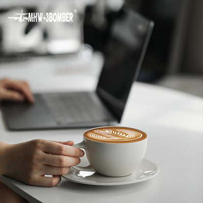 MHW-3BOMBER Mars Pencil grey cup and saucer beside a laptop